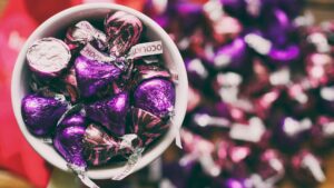 close up of foil wrapped hershey kisses in cup