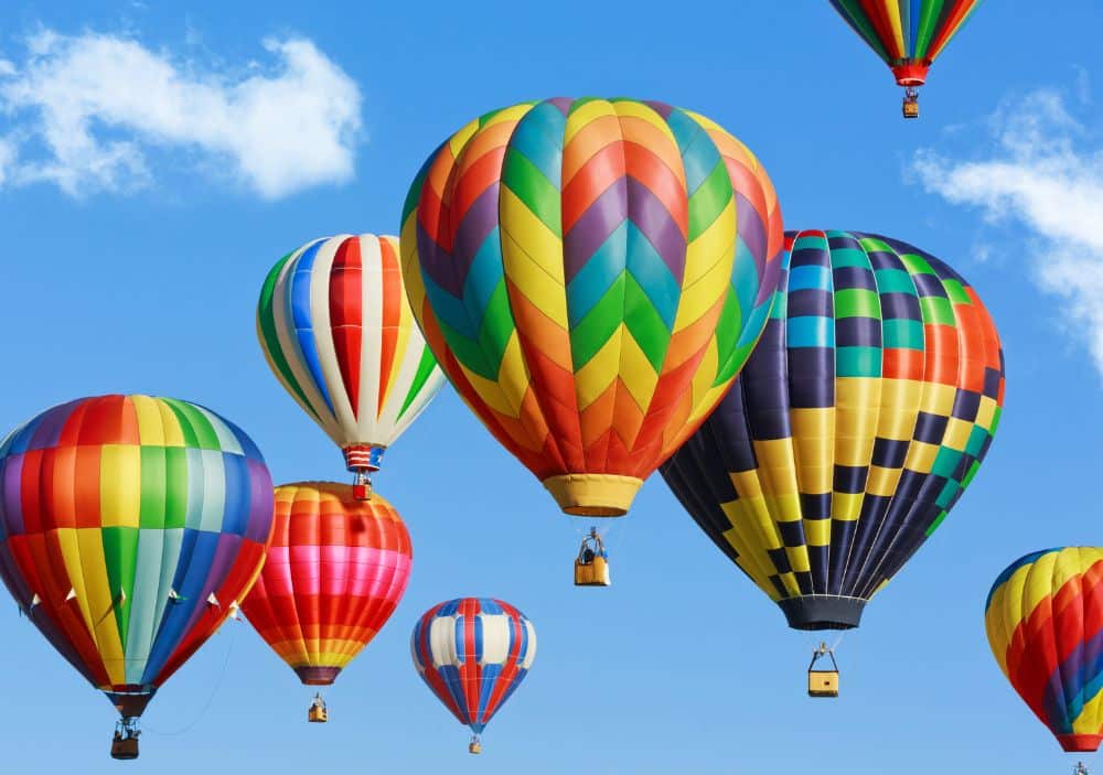 Blue sky filled with colorful hot air balloons