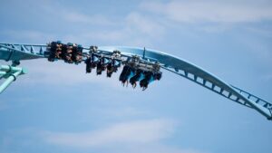 people riding roller coaster at amusement park