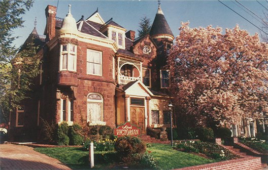 Photograph of an old mansion with large tree