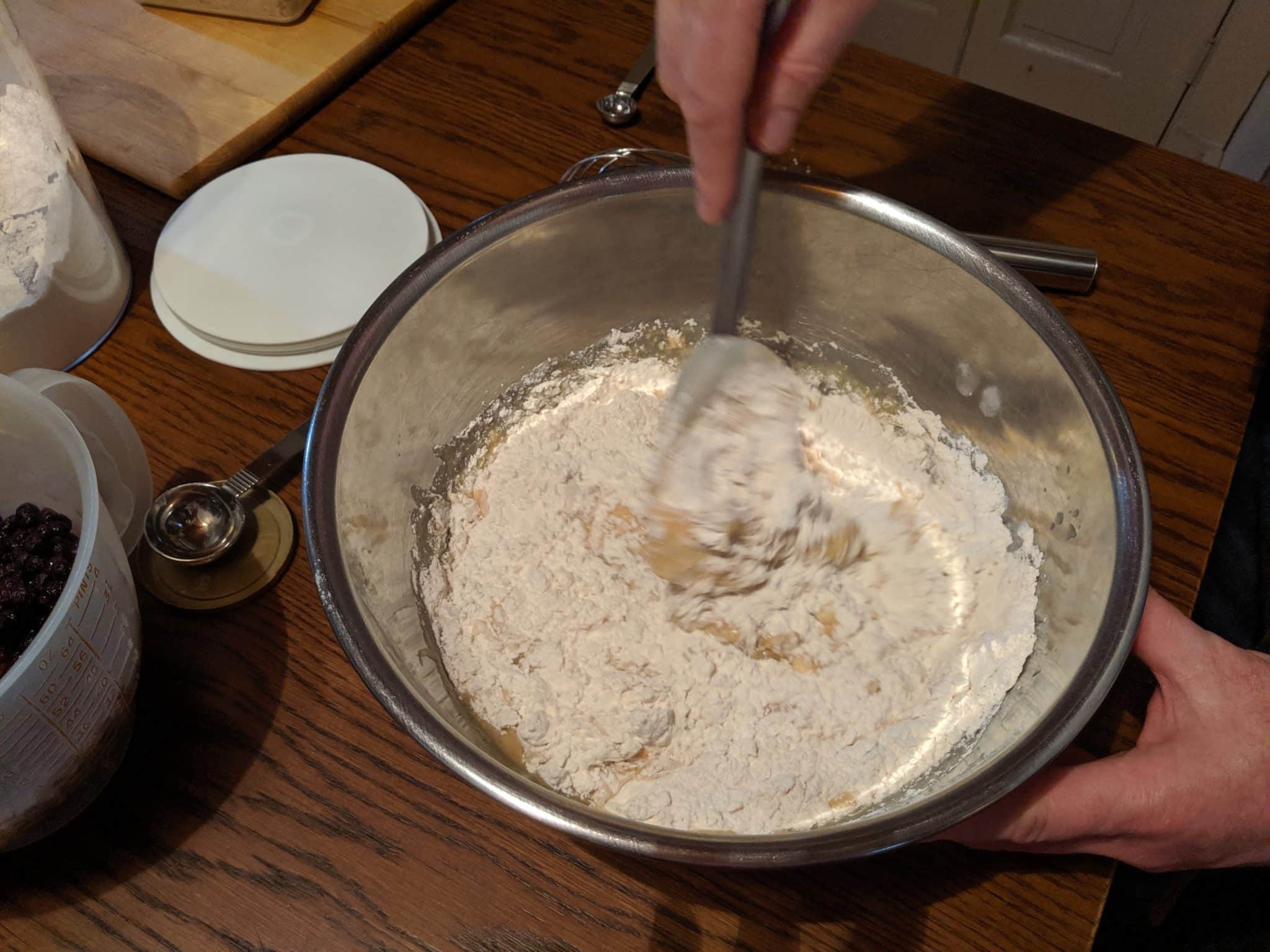dry ingredients being mixed with wet in bowl