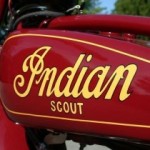 Photograph bright red gas tank of Indian Scout Motorcycle